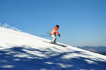 Jumping skier in the mountains