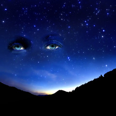 Starry sky and a view of a female eye.