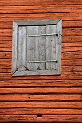 Naklejka na ściany i meble Red painted timbered barn with a gray shutter.