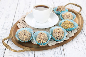 Set of chocolate candies, on tray, on color wooden background