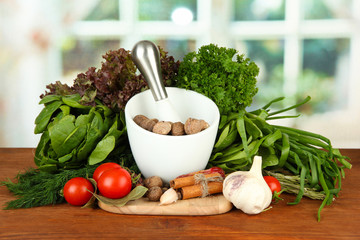 Composition of mortar, spices, tomatoes and  green herbs,