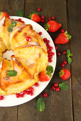 Tasty homemade cake with berries, on wooden table