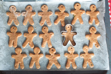 Raw gingerbread men on a baking