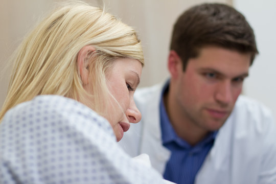 doctor talking with female patient in a hospital