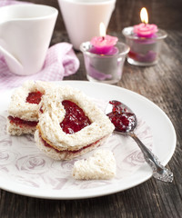 Heart shape sandwich with strawberry jam for breakfast