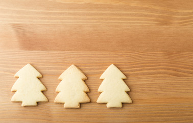 Christmas tree cookies over the wooden background