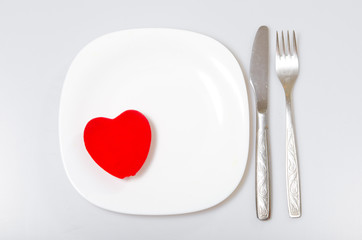 Fototapeta na wymiar red heart on a plate. Valentine's Day