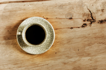 Coffee cup on wood table with copy space.