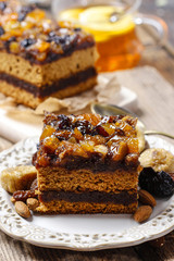 Delicious layer gingerbread cake decorated with dried fruits