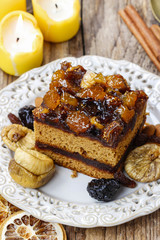 Delicious layer gingerbread cake decorated with dried fruits