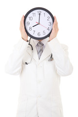 male doctor holding clock in front of face isolated on white