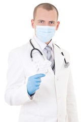 portrait of young doctor in mask with pills in hand isolated on