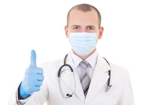portrait of young doctor in mask and blue gloves thumbs up isola