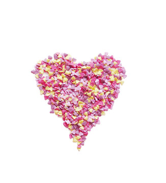 Pink heart made of candys on white background
