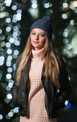 Fashionable lady wearing cap and black jacket outdoor in xmas