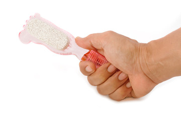 hand holding pumice stone scrub tool