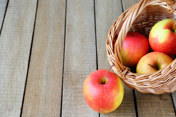 fresh apple next to a wicker basket