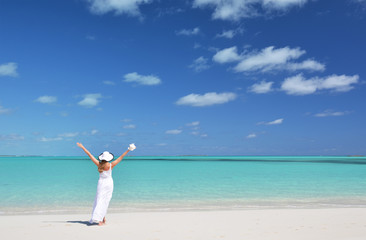 Girl in the hat on the beach of Exuma, Bahamas