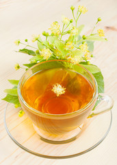 linden flowers and cup of healthy tea, herbal medicine