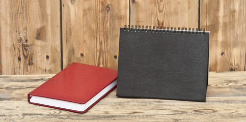 desk calendar with red leather note book on wood table