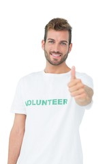 Portrait of a happy male volunteer gesturing thumbs up