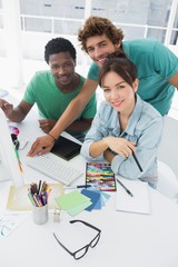 Portrait of three smiling artists at the office
