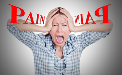 Stressed, upset, nervous young woman having headache