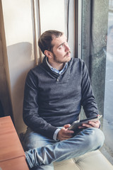 multitasking man using tablet, laptop and cellhpone