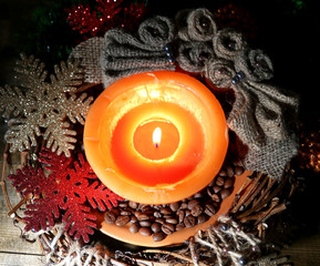 Burning candle with Christmas decorations