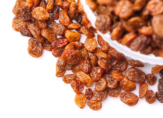 Raisins in a glass bowl over white background