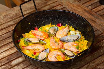 Paella in black pan