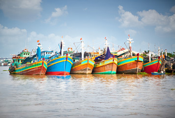 Fototapeta na wymiar Kolorowe łodzie rybackie zakotwiczony w porcie w Mekong Delta,