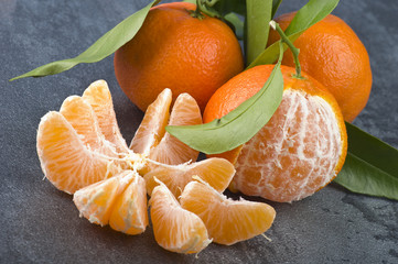 Orange mandarin or tangerine fruit with leaves