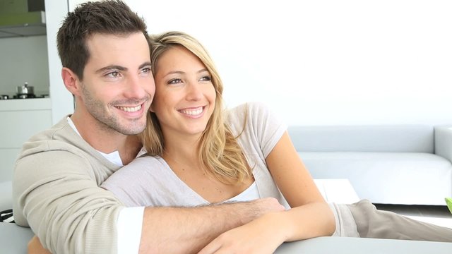 Couple relaxing in sofa and looking away