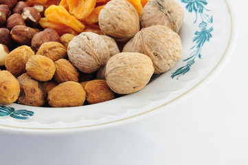 Dried fruits and nuts on the plate on left top