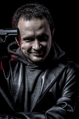 Obraz na płótnie Canvas Risk, thief, armed man with black leather jacket, dangerous