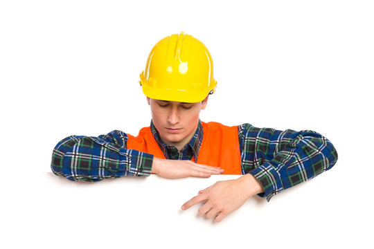 Construction worker pointing at banner.
