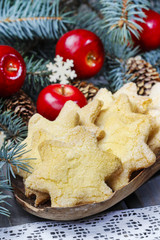Christmas cookies in star shape, red apples and green fir