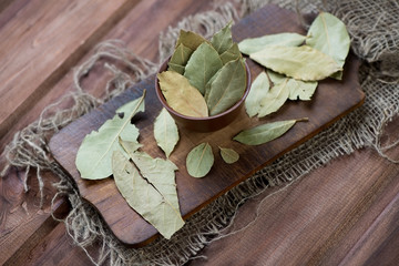 Bay leaves, rustic wooden background, above view