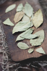 Close-up of bay leaves on a vintage cutting board