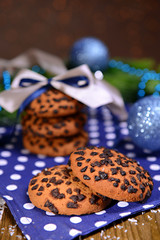 Delicious Christmas cookies in jar on table on brown background