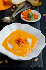 Pumpkin soup on the black background