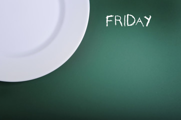 White empty plate on chalkboard background