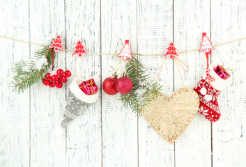 Christmas accessories hanging on white wooden wall