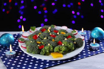 Fototapeta na wymiar Christmas tree from broccoli on table on dark background