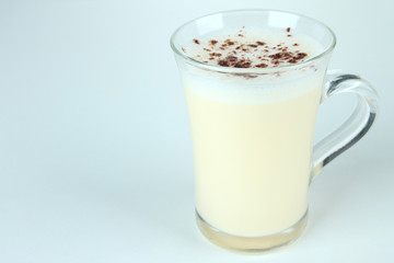 Cup of eggnog isolated on white