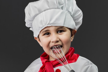 Childhood, Little boy preparing healthy food on kitchen over gre