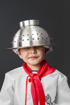 Cuisine, little boy preparing healthy food on kitchen over grey