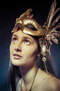 Vintage warrior woman with gold mask, long hair brunette. Long h