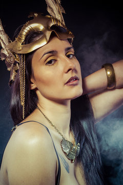 Vintage warrior woman with gold mask, long hair brunette. Long h
